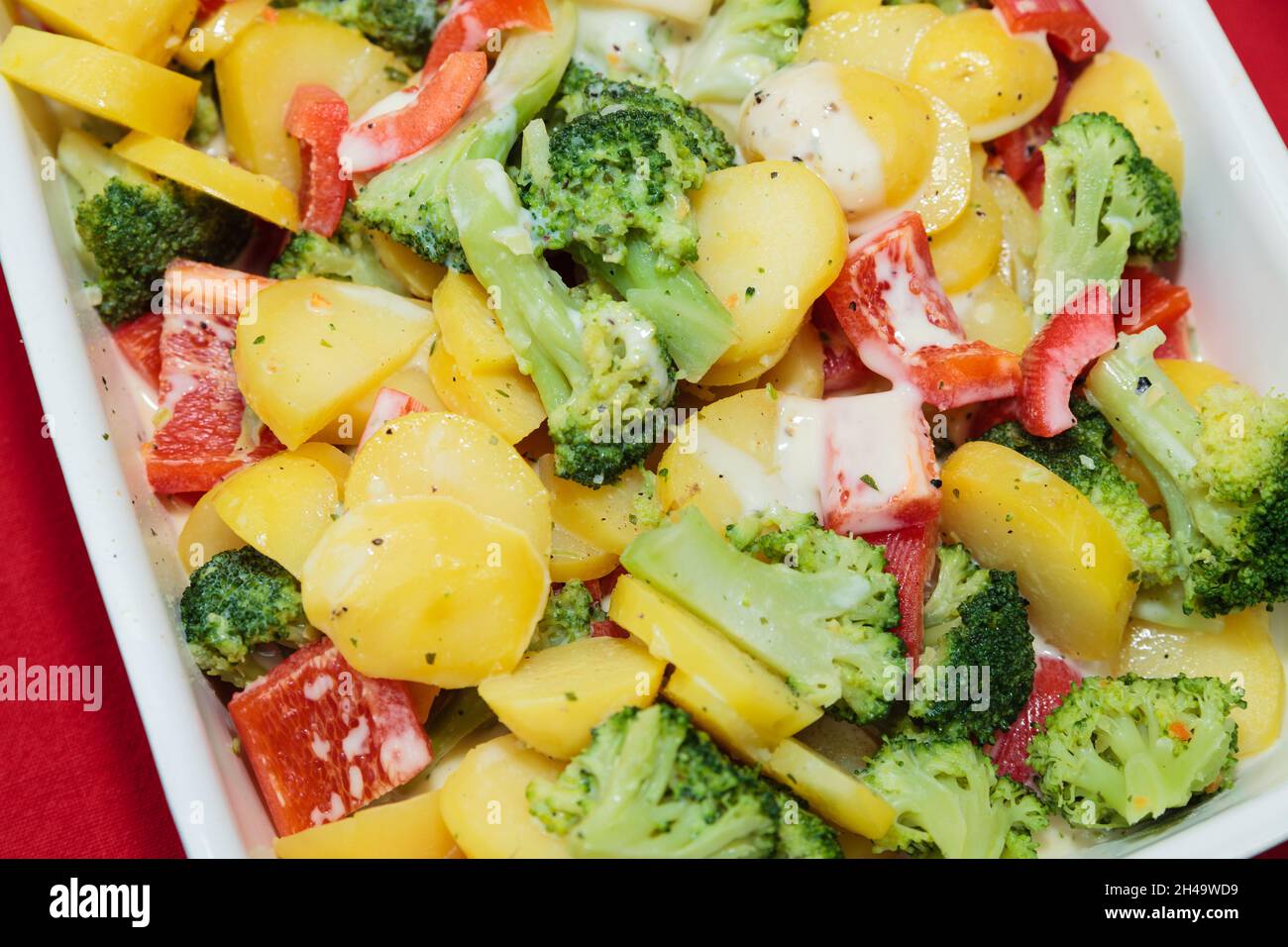 Details of a potato casserole in a baking dish served with wine Stock Photo