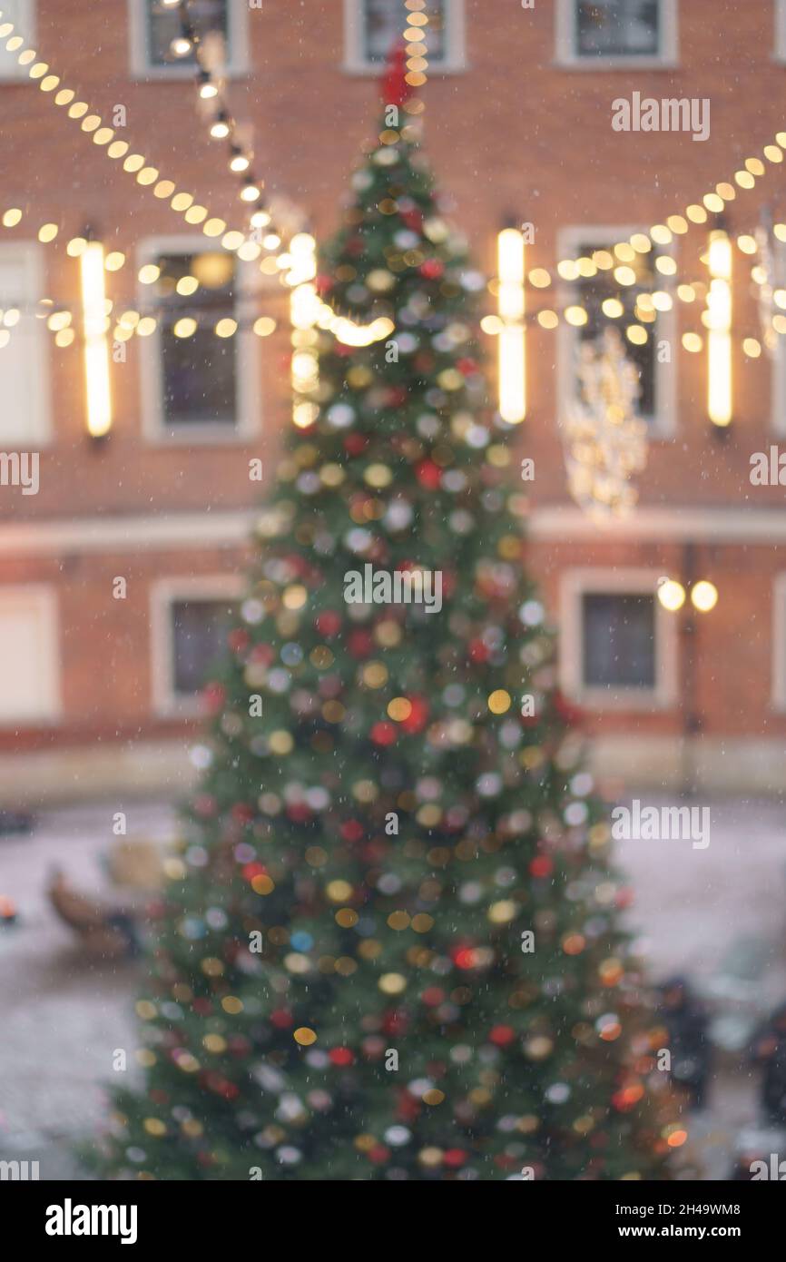 Christmas tree with glowing lights. Old town with pine decorated with