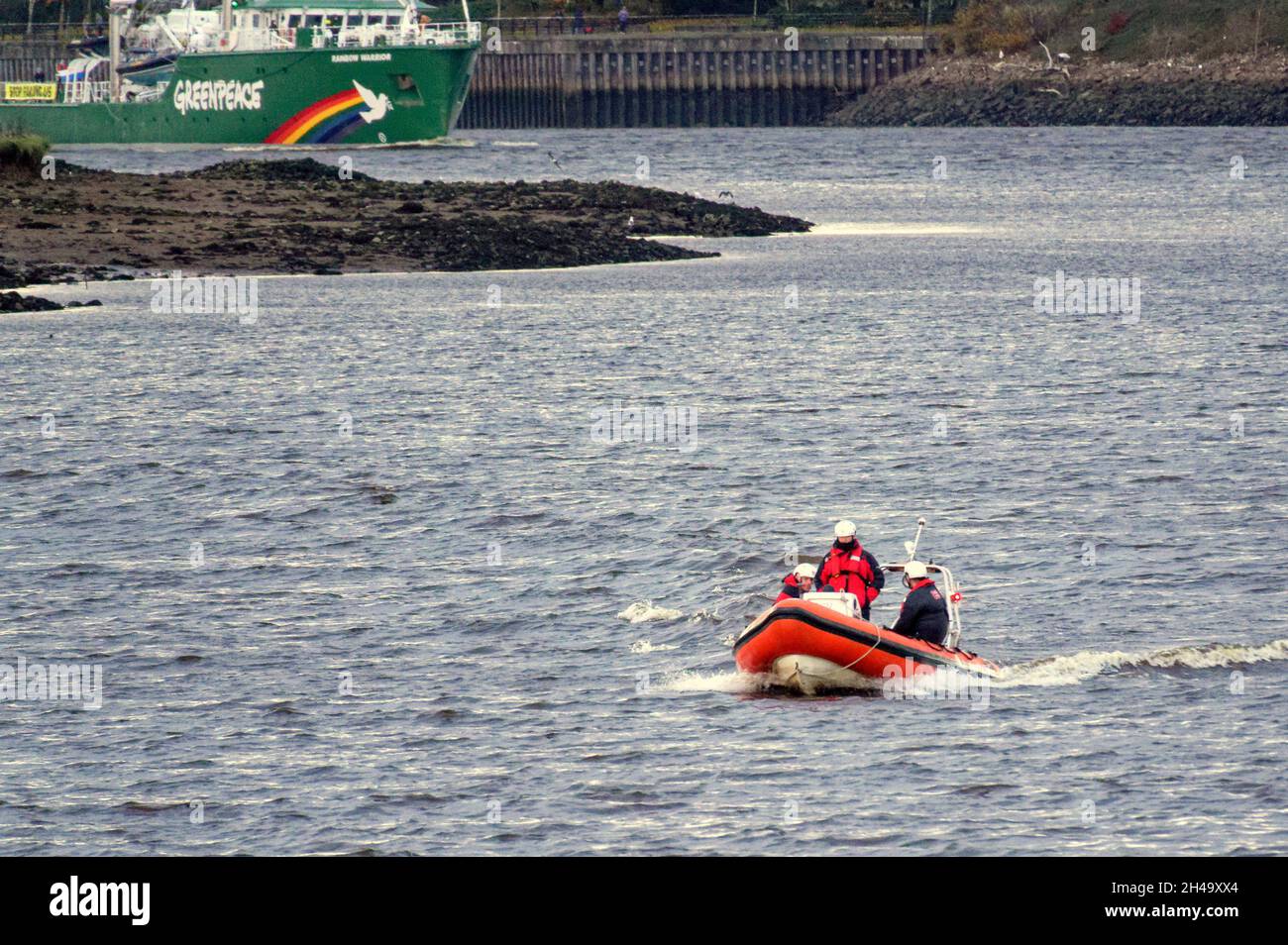 Glasgow, Scotland, UK 1st November, 2021.UK  Weather: Rainbow warrior passed under the erskine bridge into the clyde and by the clyde titan old shipbuilding crane where the great clyde liners were built  waved on by onlookers in clydebank escorted by rnli rubber dingy and a helicopter. .  Credit: Gerard Ferry/Alamy Live News Stock Photo