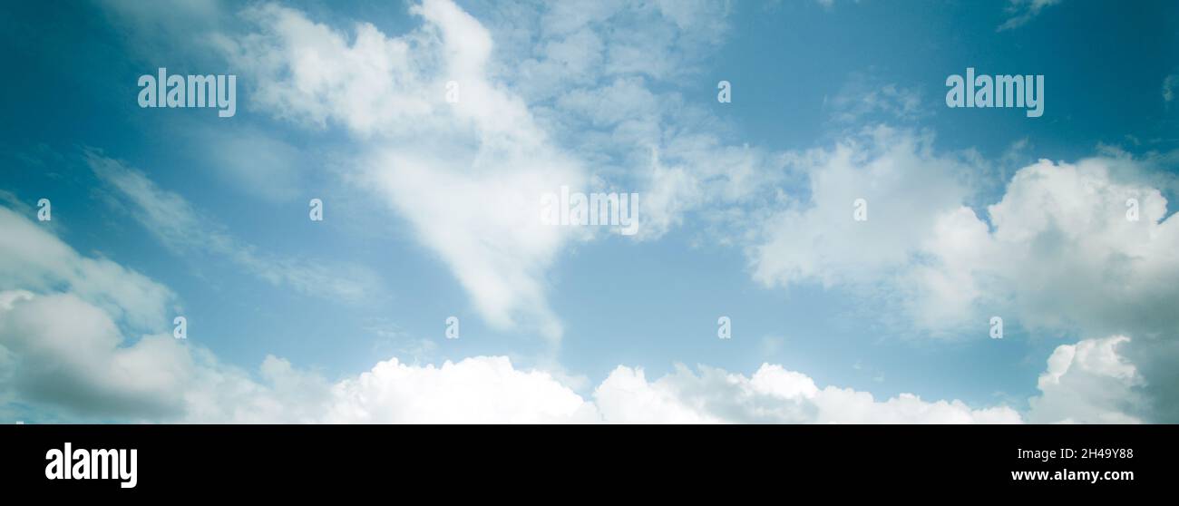 wide retro color summer clouds in blue sky Stock Photo