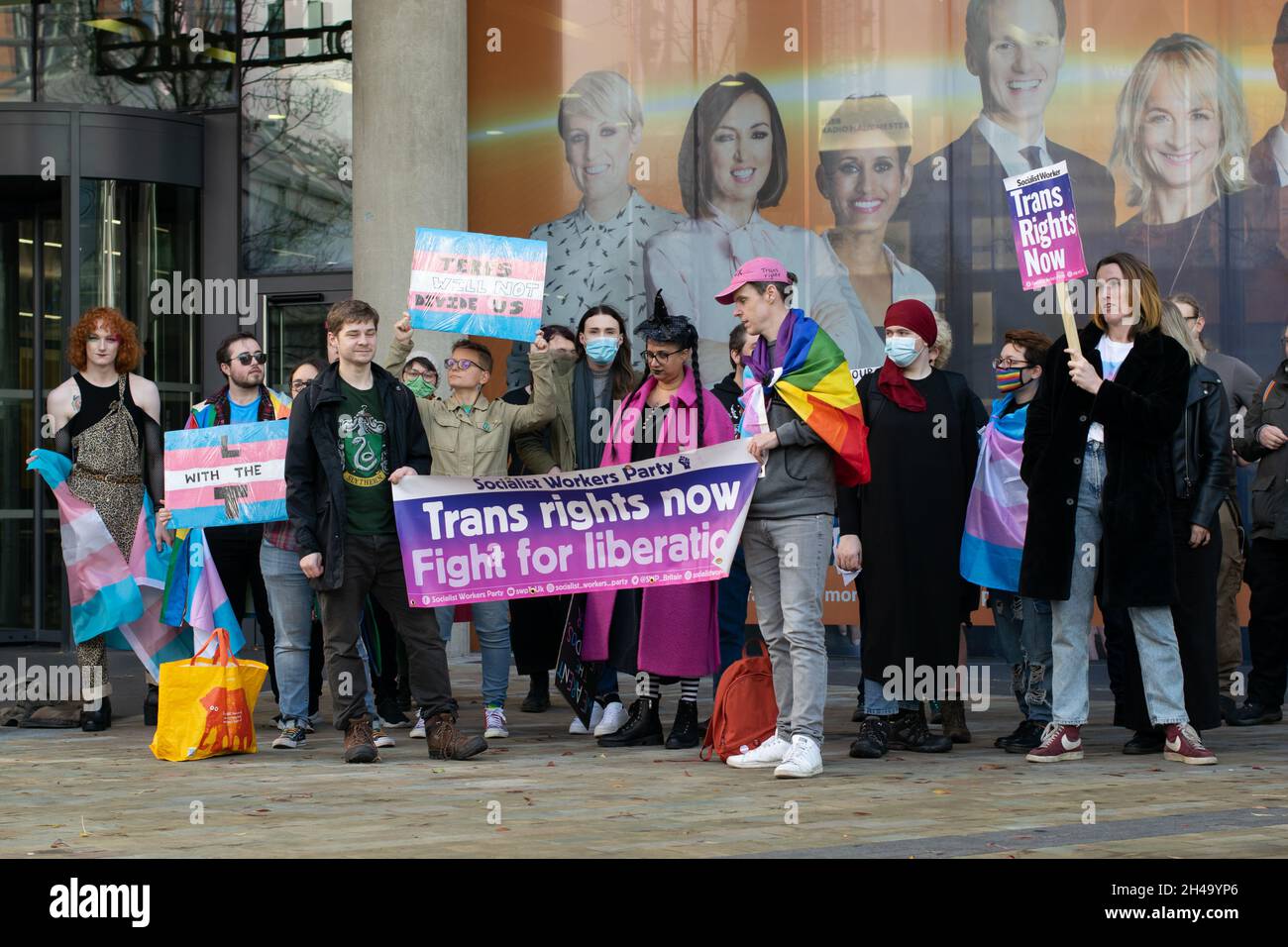 Trans rights protest outside the BBC studio Salford Quays Media City. Sign text L with the T and Trans Rights Now Stock Photo
