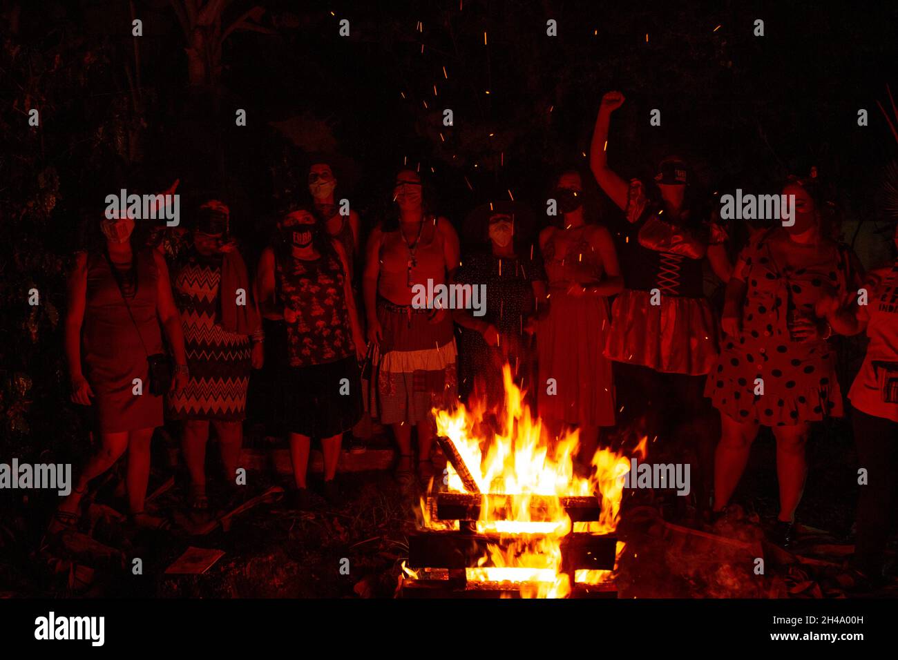 Several women around a campfire. Red Witches Night - was a politically focused Halloween event against President Jair Bolsonaro. Stock Photo