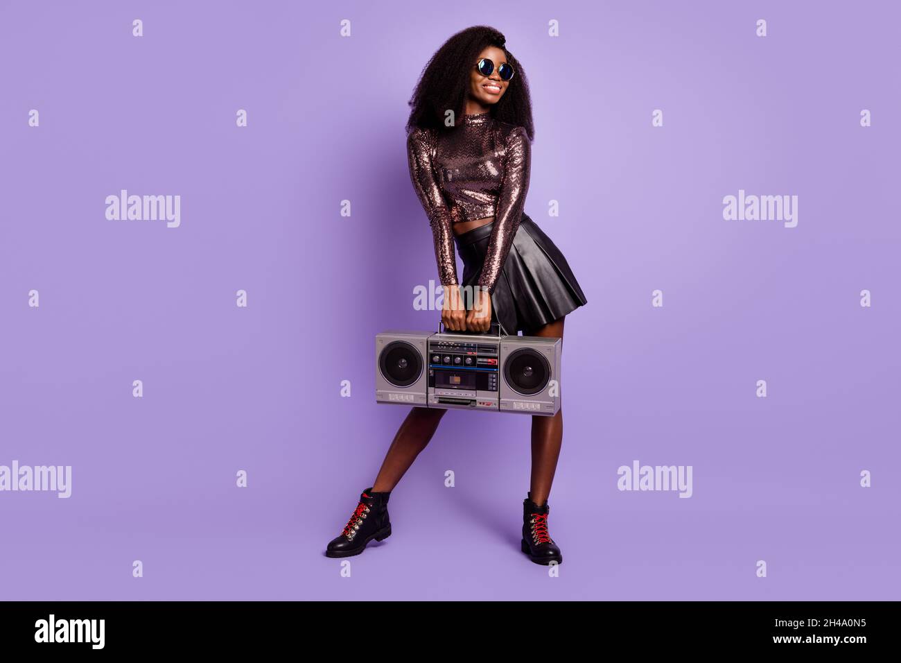 Photo of lady hold radio look empty space wear retro glasses glossy shirt short skirt isolated purple color background Stock Photo