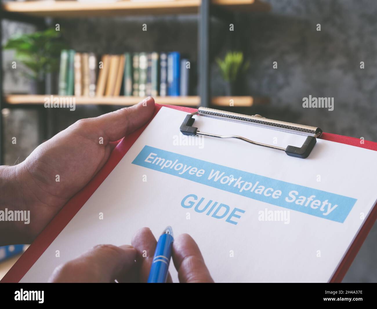 Man reads employee workplace safety guide in the office. Stock Photo