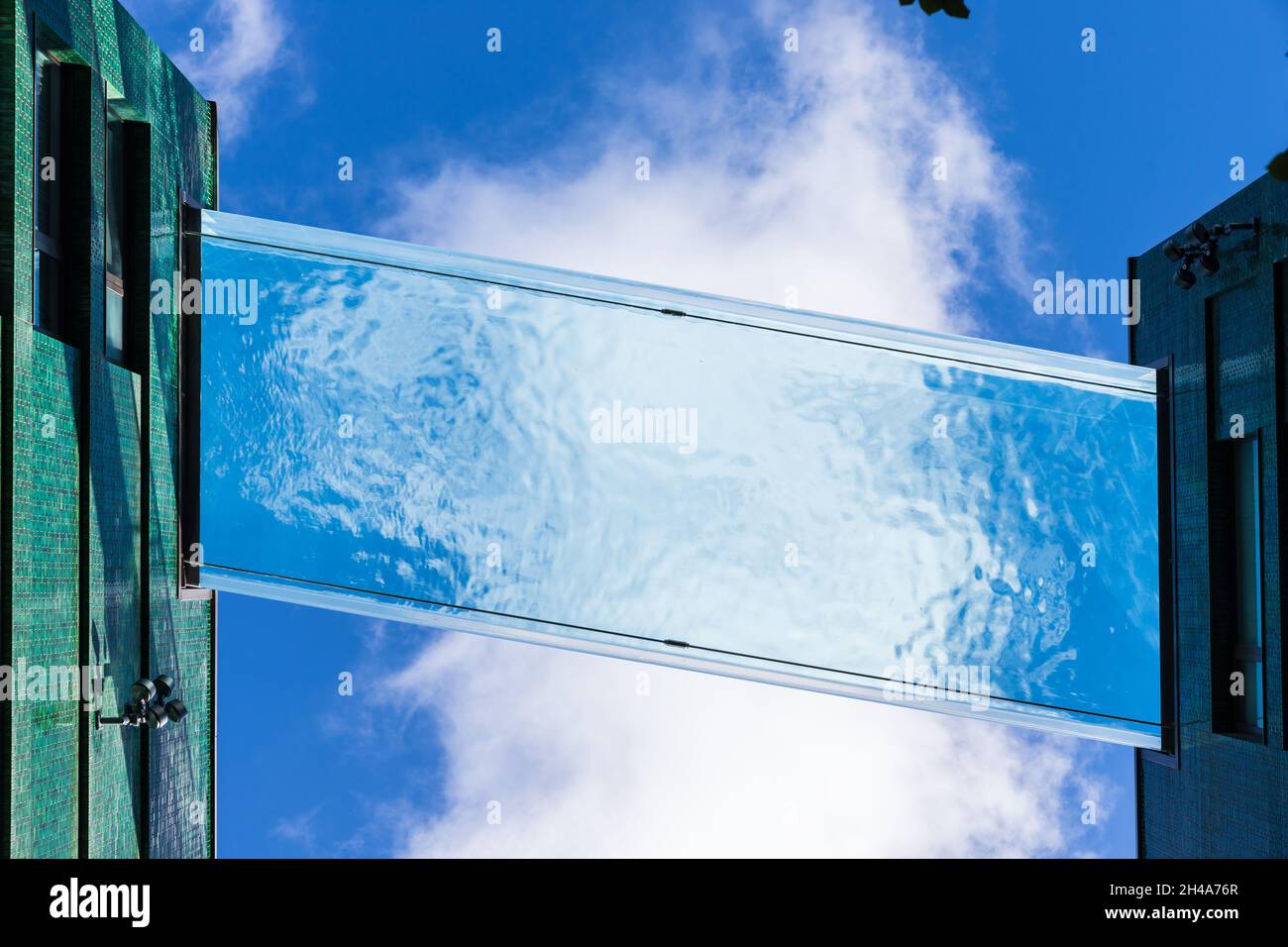 Nine Elm glass swimming pool from below Stock Photo