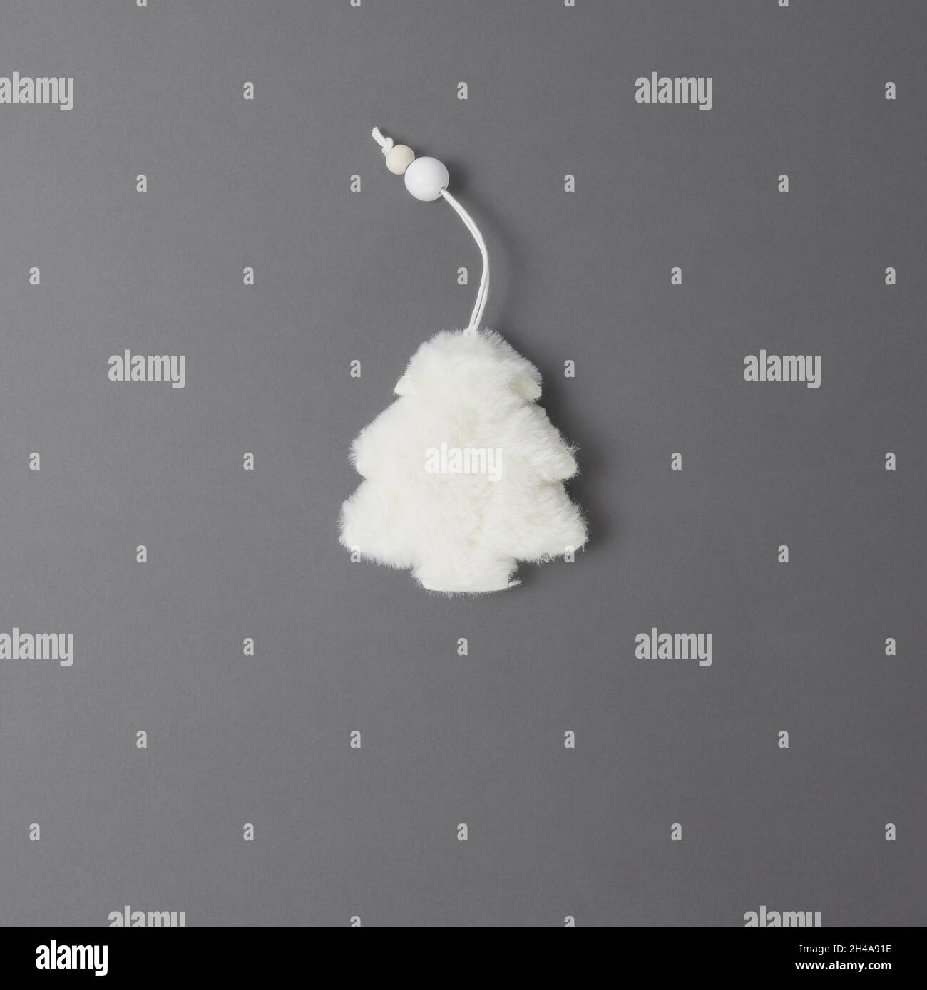 Fluffy white fur tree on a gray background. View from above Stock Photo