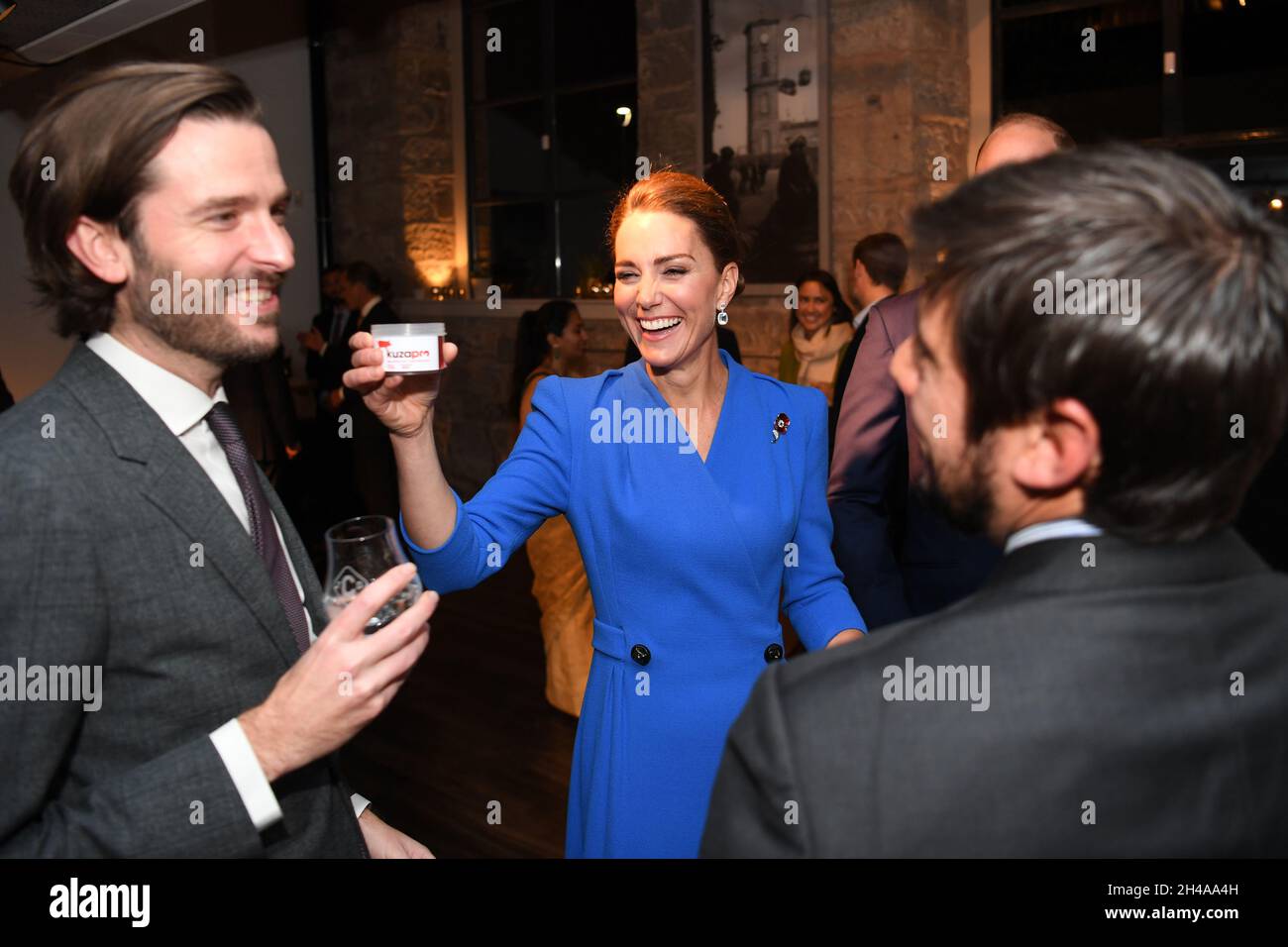 The Duchess of Cambridge (centre) laughs as she offers a tub of dead larvae, used as livestock feed, to guests at a reception at the Clydeside Distillery, Glasgow, for the key members of the Sustainable Markets Initiative and the Winners and Finalists of the first Earthshot Prize Awards as the COP26 UN Climate Change Conference takes place in Glasgow. Picture date: Monday November 1, 2021. Stock Photo