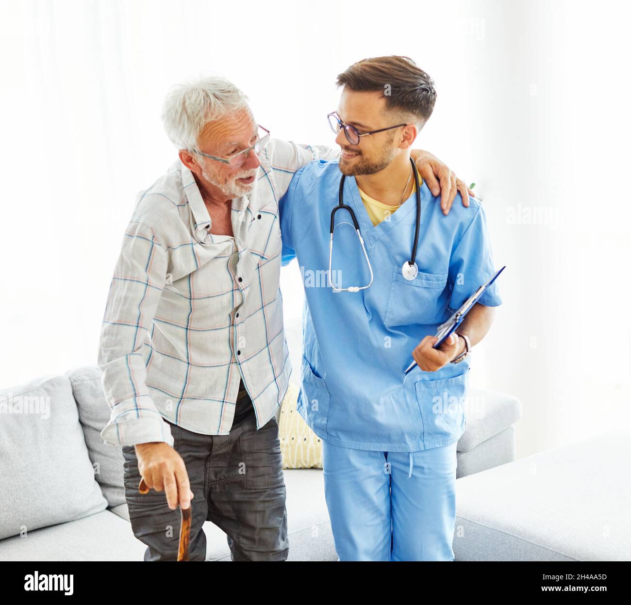 nurse doctor senior care caregiver help assistence walking cane stick retirement home nursing support man Stock Photo