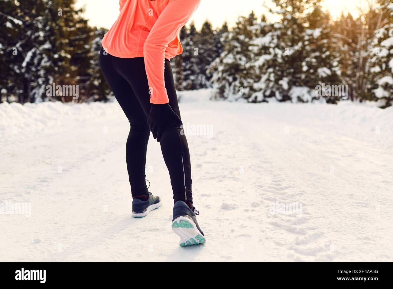 Stretching, trauma, pain of the legs when running in winter. Stock Photo