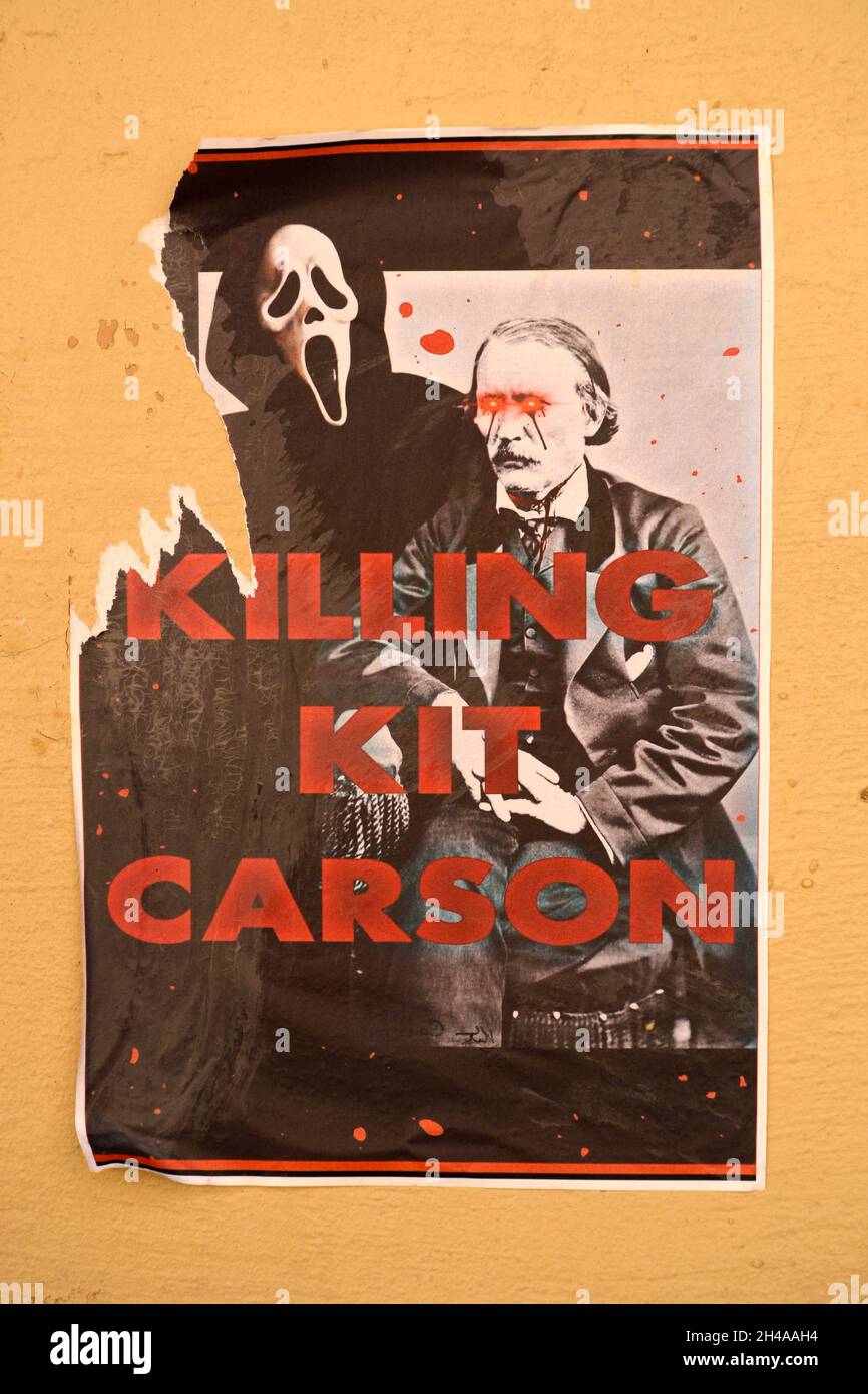 Posters shaming 19th century American frontiersman, Indian agent and U.S. Army officer Kit Carson glued to walls in Santa Fe, New Mexico. Stock Photo