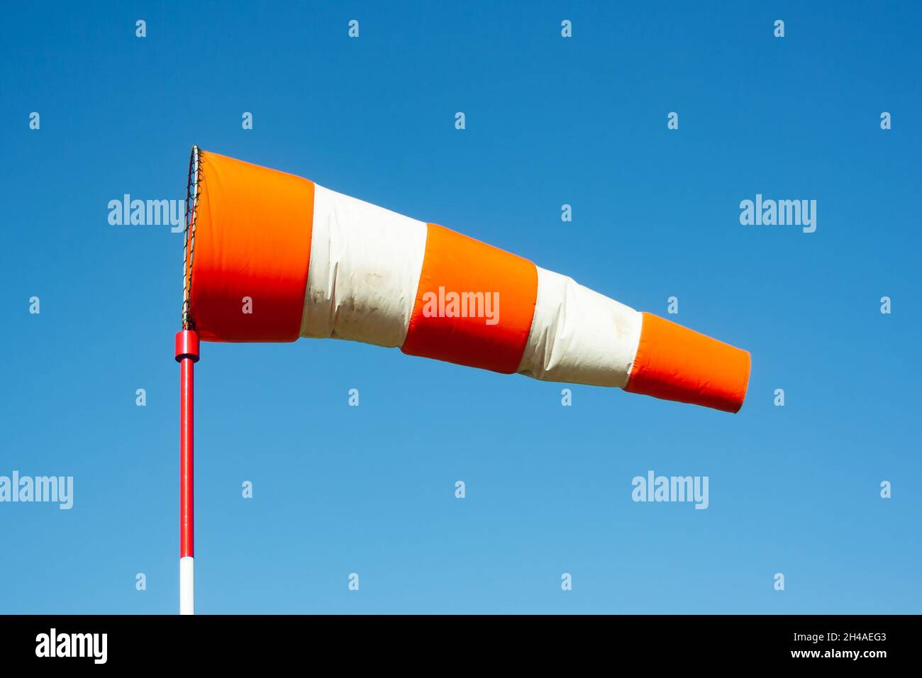 Airport wind sock. Strong wind and bad weather symbol. Climate change. Meteorology forecast. Storm is coming. Stock Photo