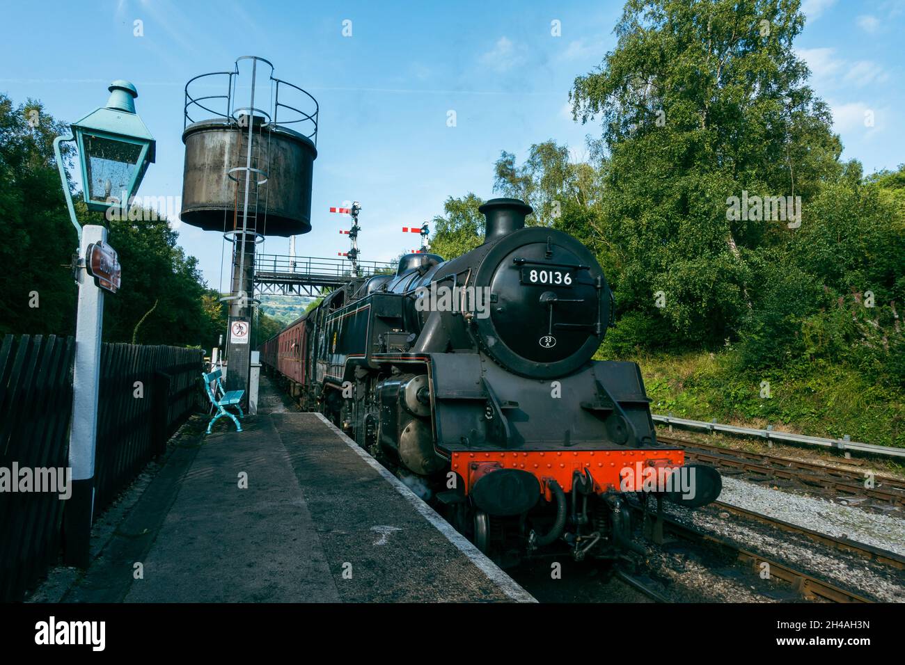 Steam train, The Moorlander,after filling up with water from the water tower, Grosmont station on the North York Moors Heritage Railway, UK Stock Photo