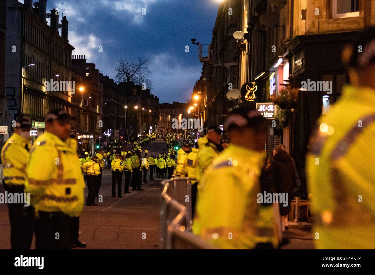 Glasgow, Scotland, UK. 1st Nov, 2021. COP26 - temporary ring of steel around Kelvingrove Museum and massive police presence in the surrounding areas of the West End of Glasgow ahead of a COP26 evening reception. Pictured - police line Argyle Street through Finnieston which has been completely sealed off to create a safe route for world leaders arriving at Kelvingrove Museum from the SEC campus. Women were reduced to tears as they were advised to walk through a dark Kelvingrove Park detour in order to get home as they were not allowed to crossed the road Credit: Kay Roxby/Alamy Live News Stock Photo