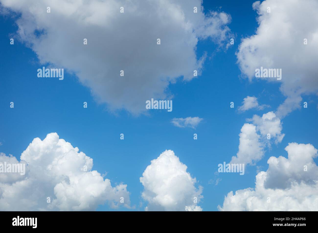 Puffy white clouds against a blue sky Stock Photo