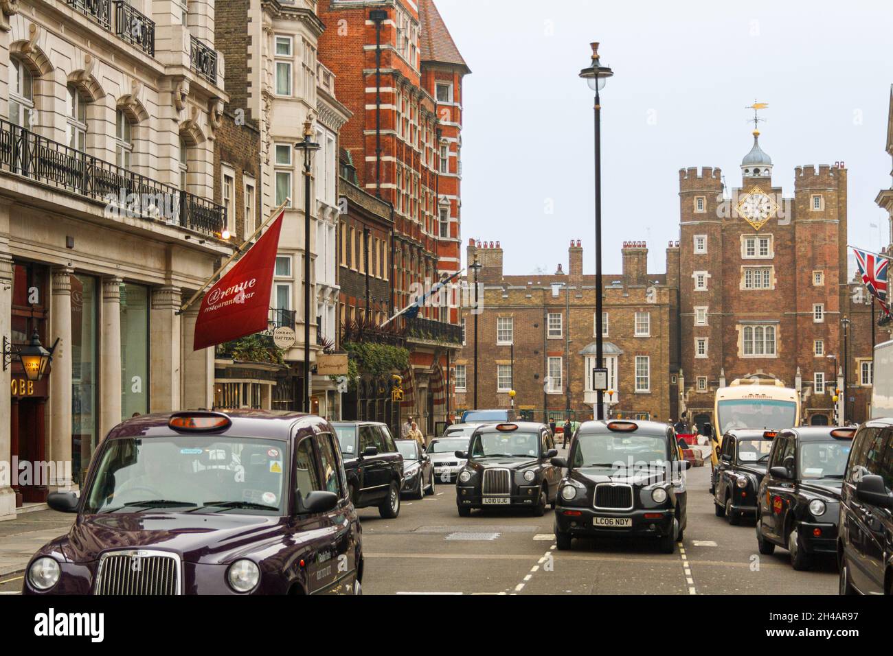 London, United Kingdom; March 15th 2011: Taxis on Saint James Street, with the palace of the same name in the background. Stock Photo