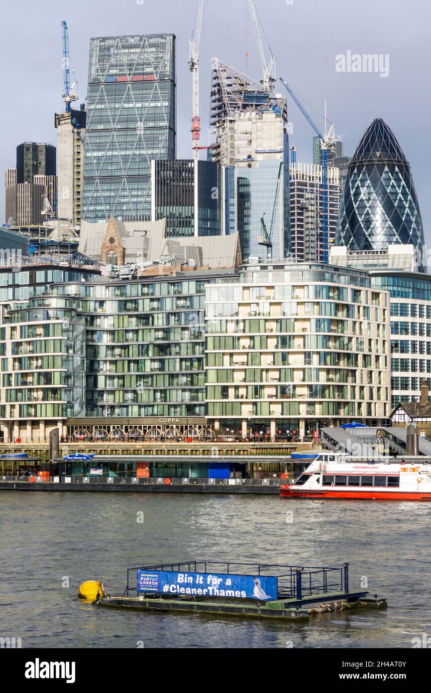 A Thames rubbish barge in front of the City of London. Stock Photo