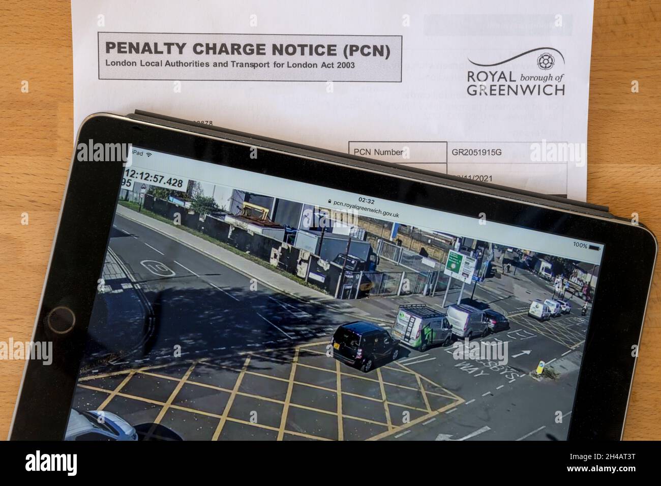A Penalty Charge Notice for stopping in a box junction with camera evidence on ipad.  NB data anonymised. Stock Photo