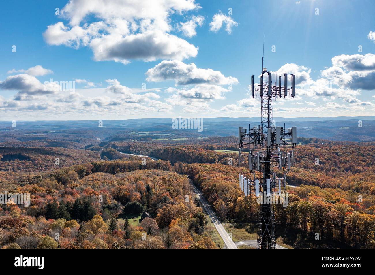Aerial view of mobile phone cell tower over forested rural area of West Virginia to illustrate lack of broadband internet service Stock Photo