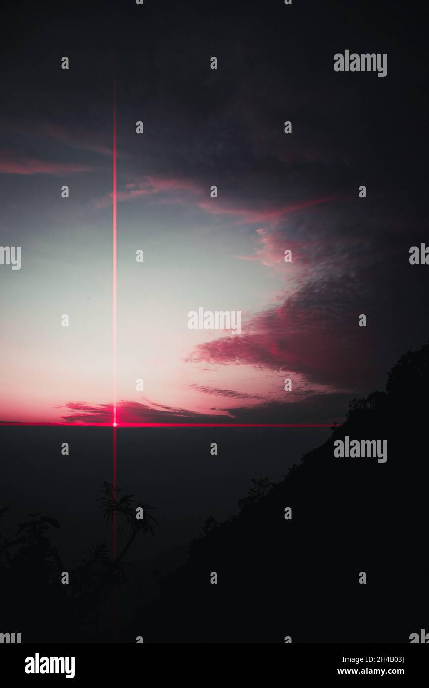 Vertical shot of the cloudy night sky with a laser light Stock Photo ...