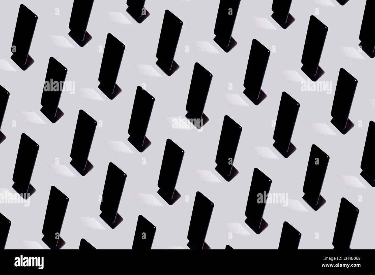 Floating mobile phone pattern on gray background. Creative top view layout with shadows and mirror. Technology idea. Communications concept. Stock Photo