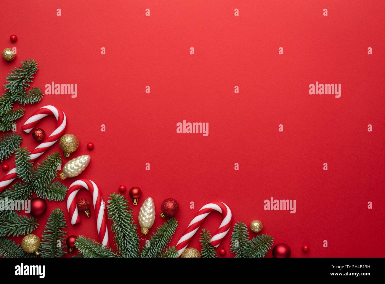 Christmas or New Year red background with fir decor. Blank for advertising text with copy space. Top view, flat lay Stock Photo
