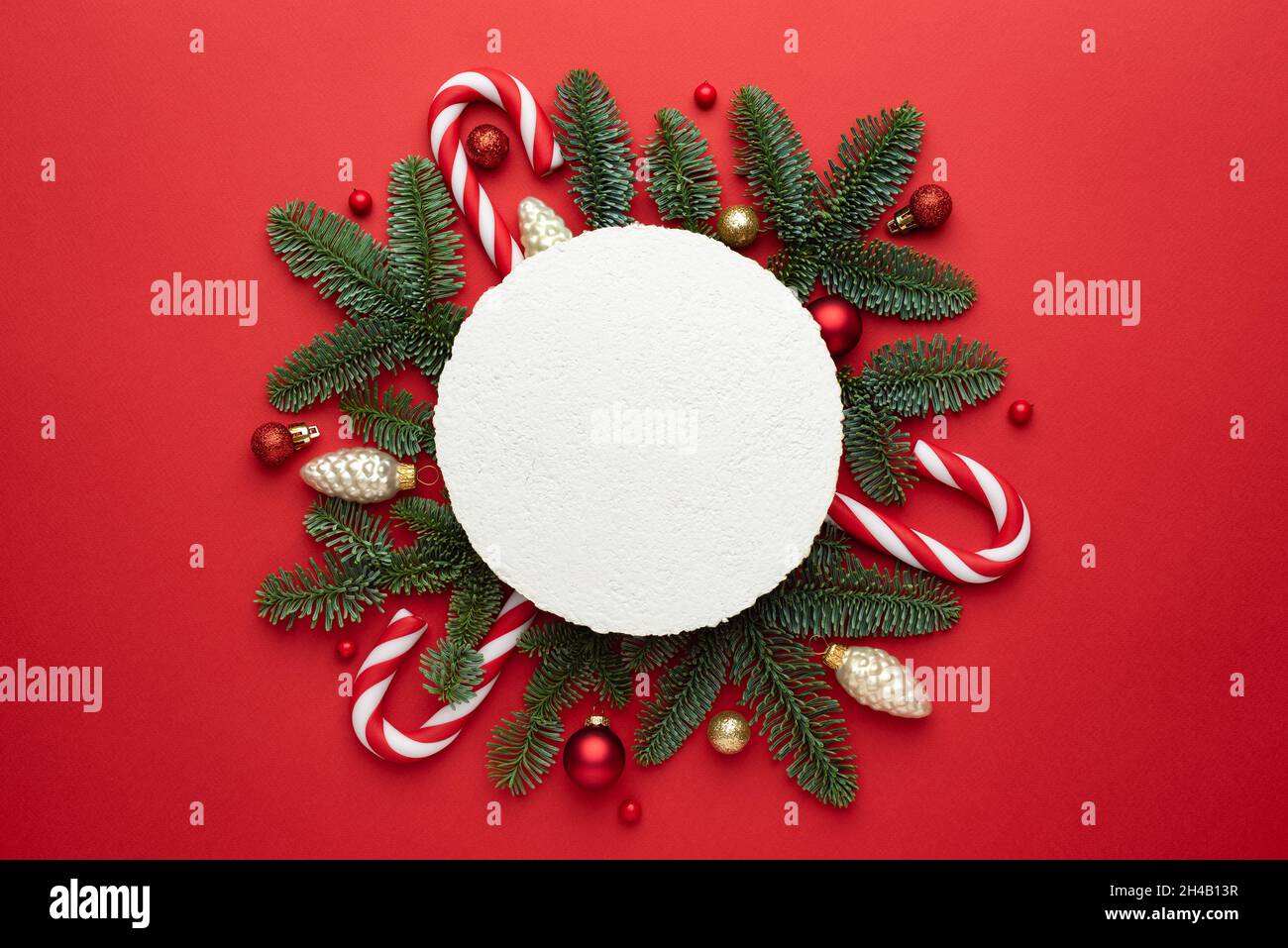 Festive Christmas background with a frame made of decorated fir branches and sleigh bells Stock Photo