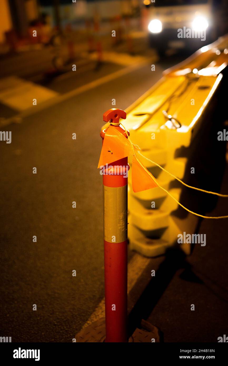 Vertical shot of a tall traffic cone in the streets of Nambour