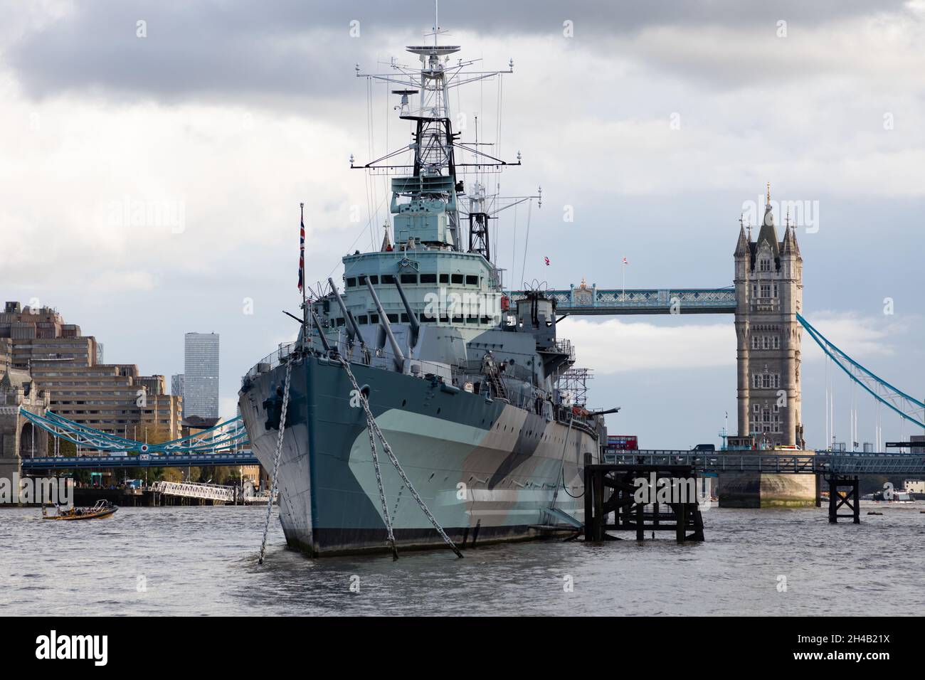 HMS Belfast, a museum ship operated by the Imperial War Museum, moored on the River thames close to Tower Dridge Stock Photo
