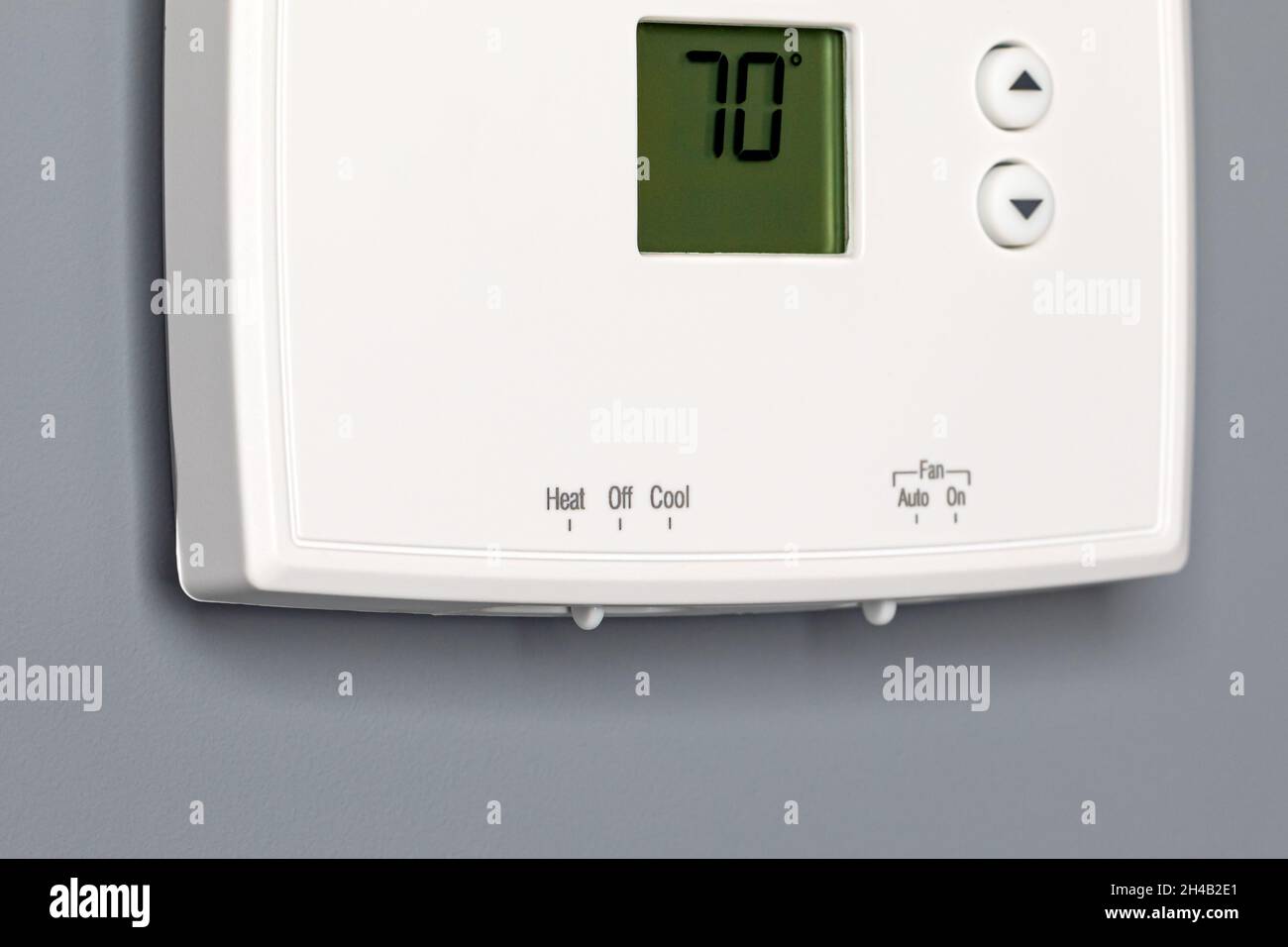 Thermostat for home furnace and air conditioner. Utility bill savings, energy cost and conservation concept Stock Photo
