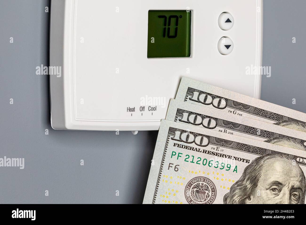 Thermostat for home furnace and air conditioner. Utility bill savings, energy cost and conservation concept Stock Photo