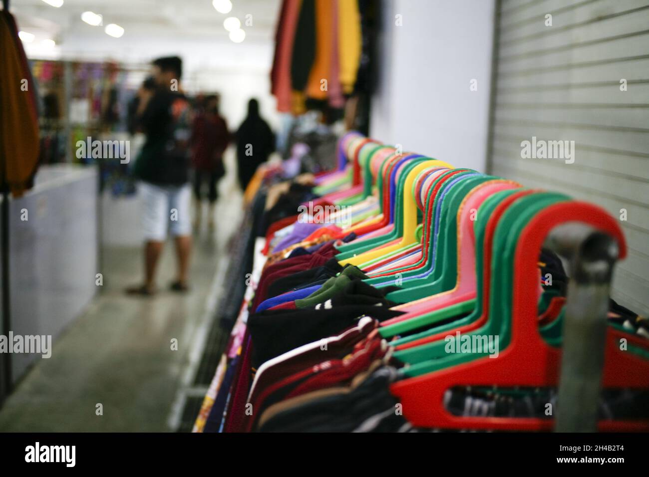 Shot of colorful coat hangers in a row inside a boutique Stock Photo