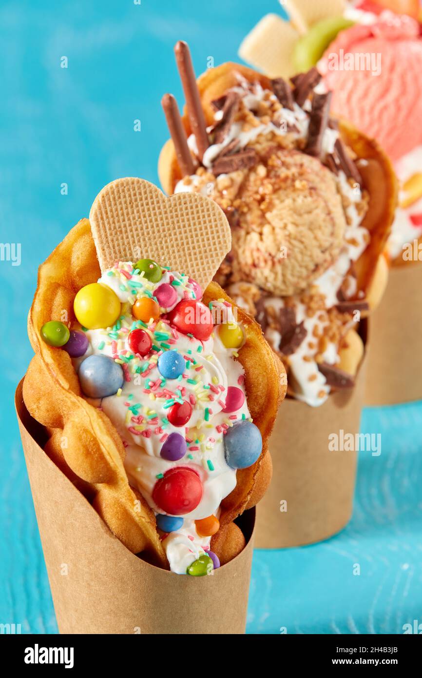 Closeup shot of bubble waffle ice cream in paper packages on a blue ...