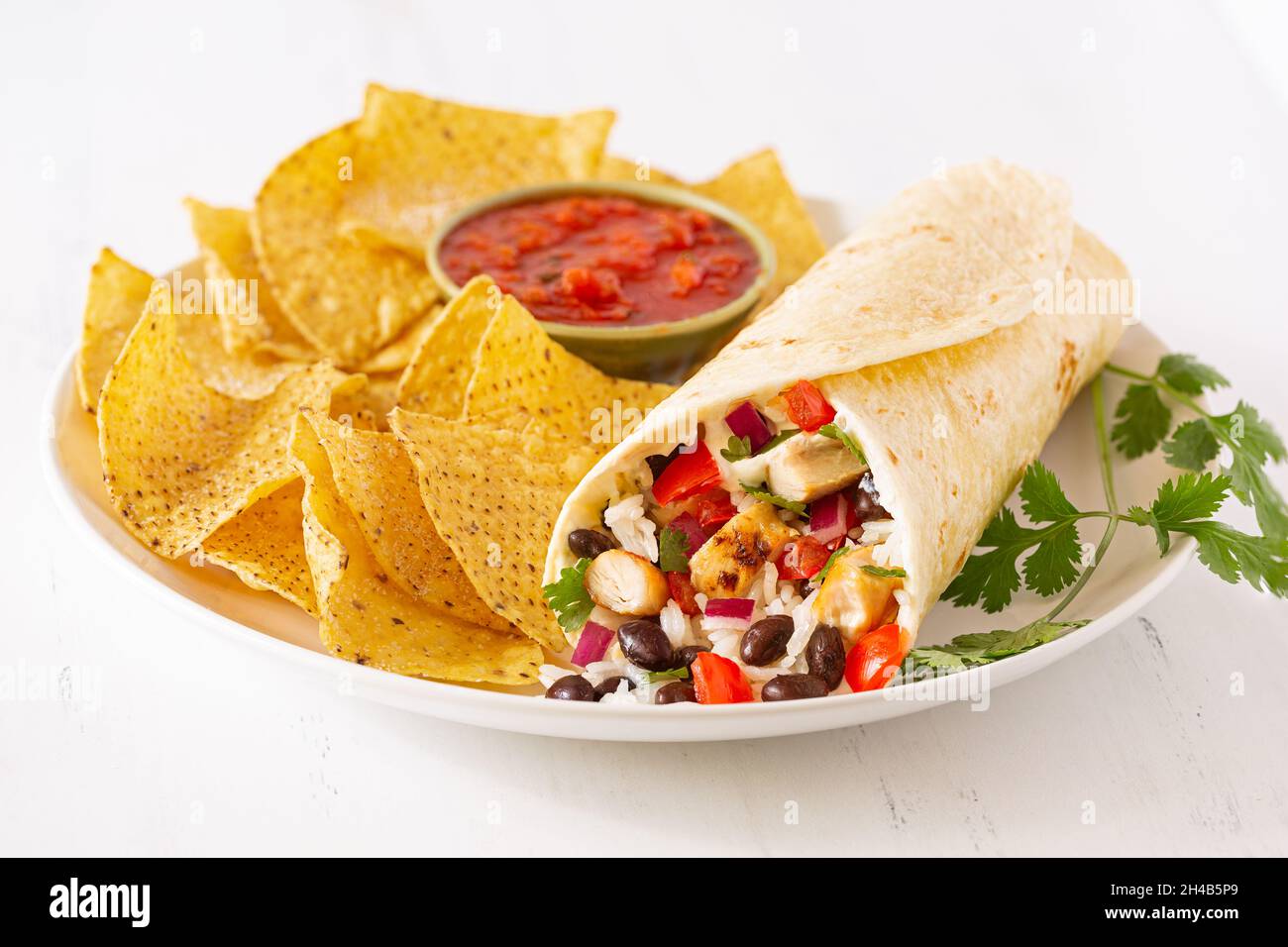 Fresh chicken and black bean burrito with tortilla chips and salsa