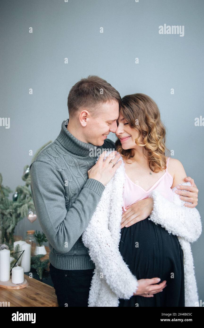 Man hugs his pregnant wife. She hugs her stomack smiling Stock Photo ...