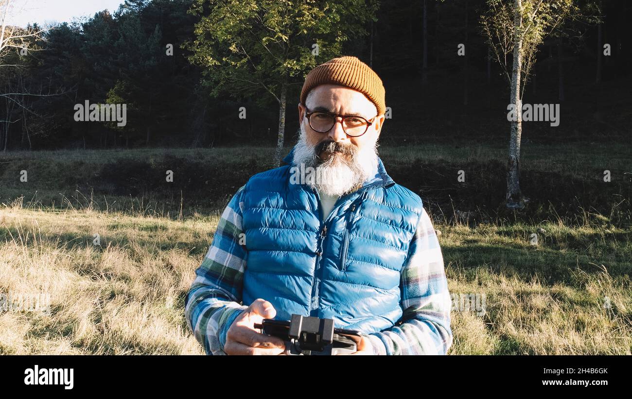 portrait of a man operating the remote control of a drone. Stock Photo