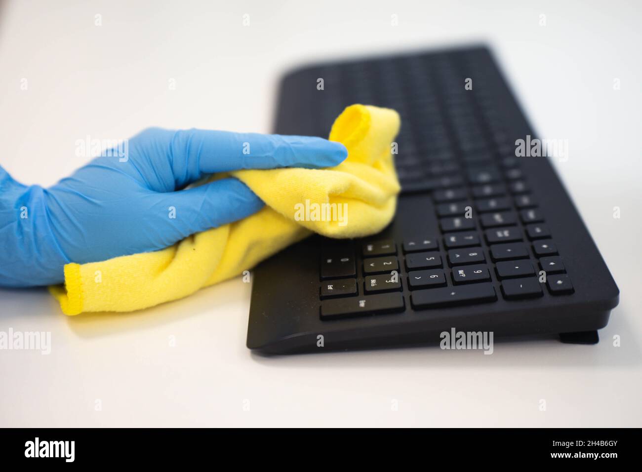 Hand wiping the keyboard from dust Stock Photo Alamy