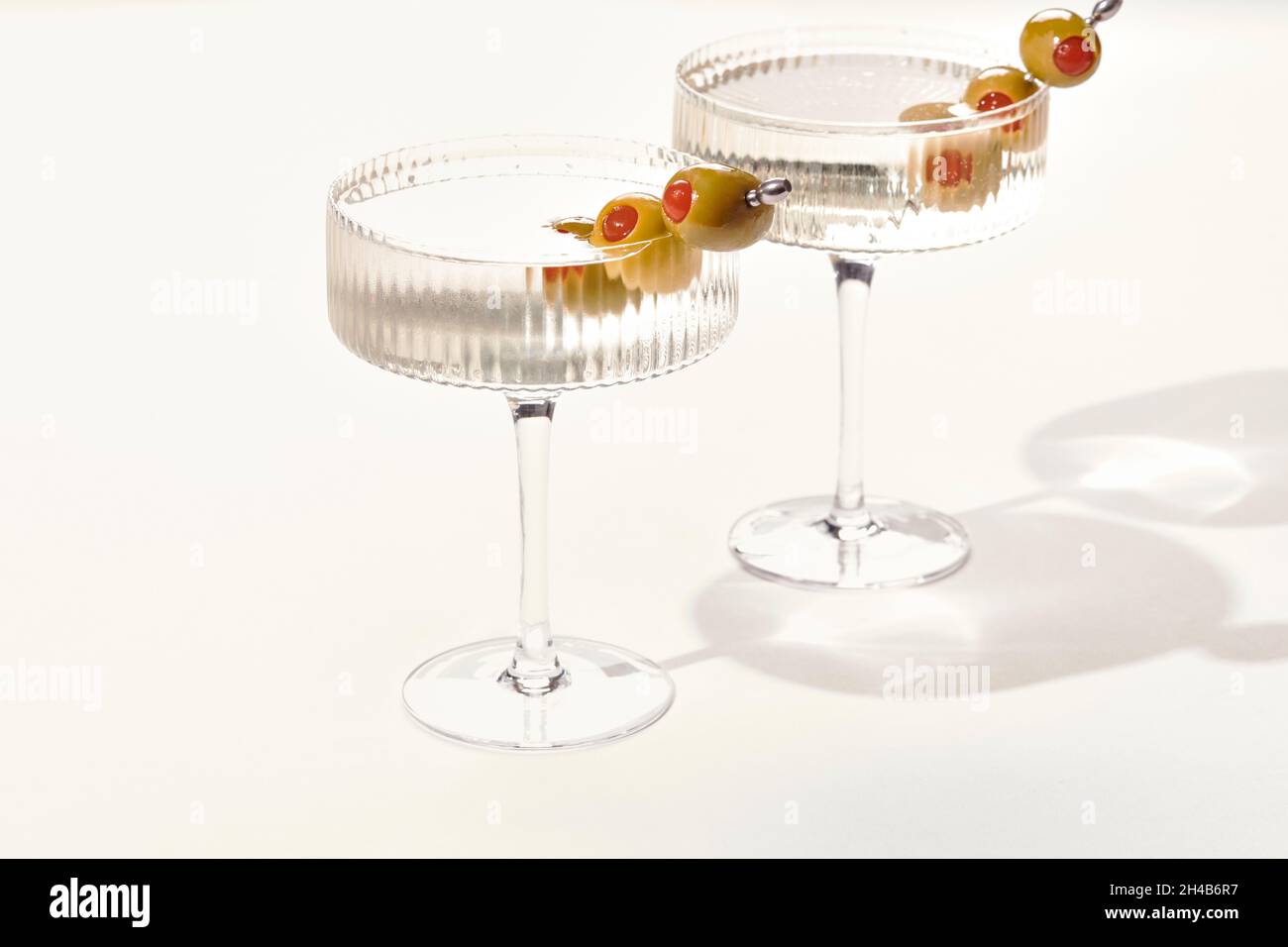 Two vodka or gin martini swith olives on white background Stock Photo