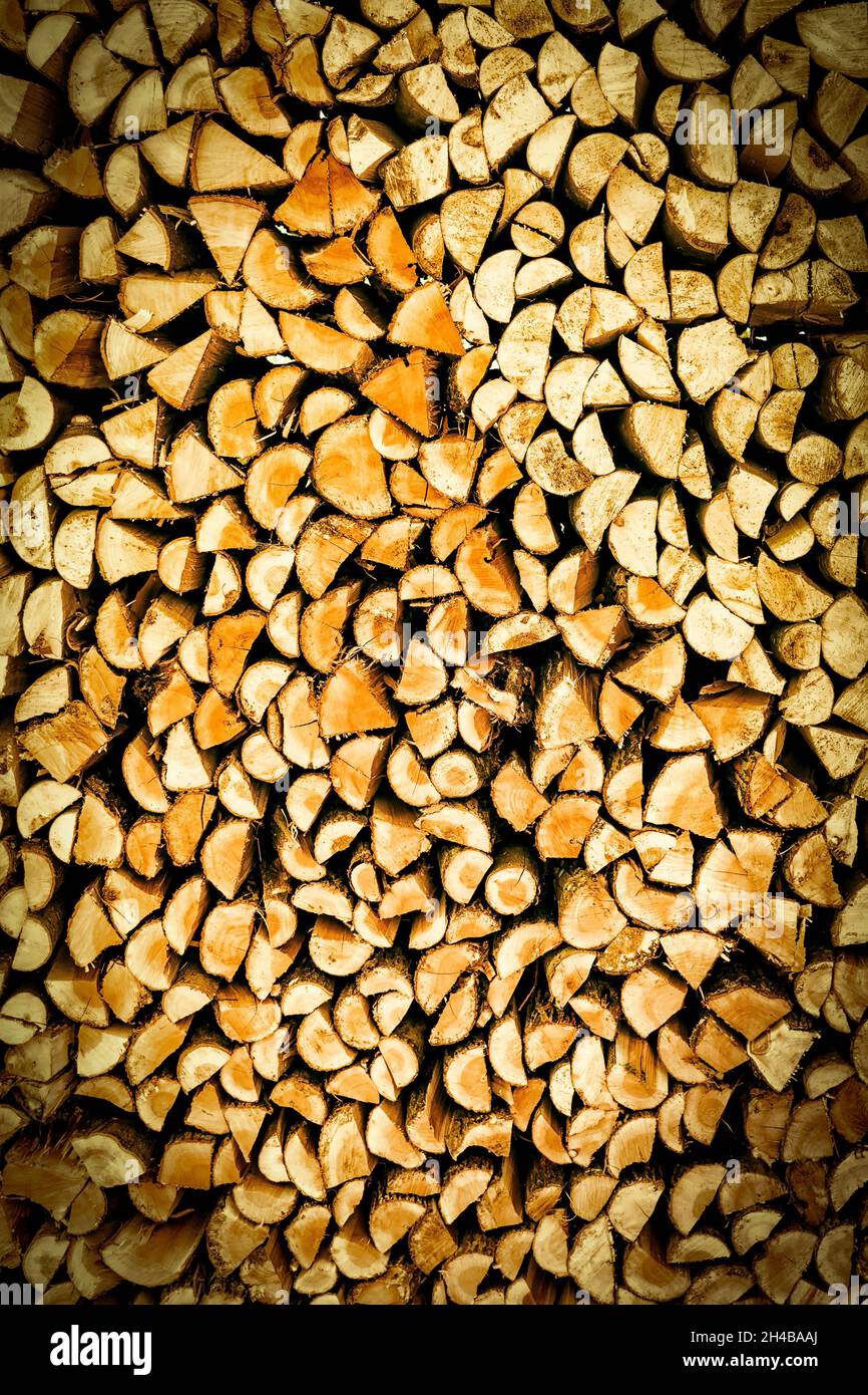 chopped wood firewood to make fire on the stove in winter, vertical Stock Photo