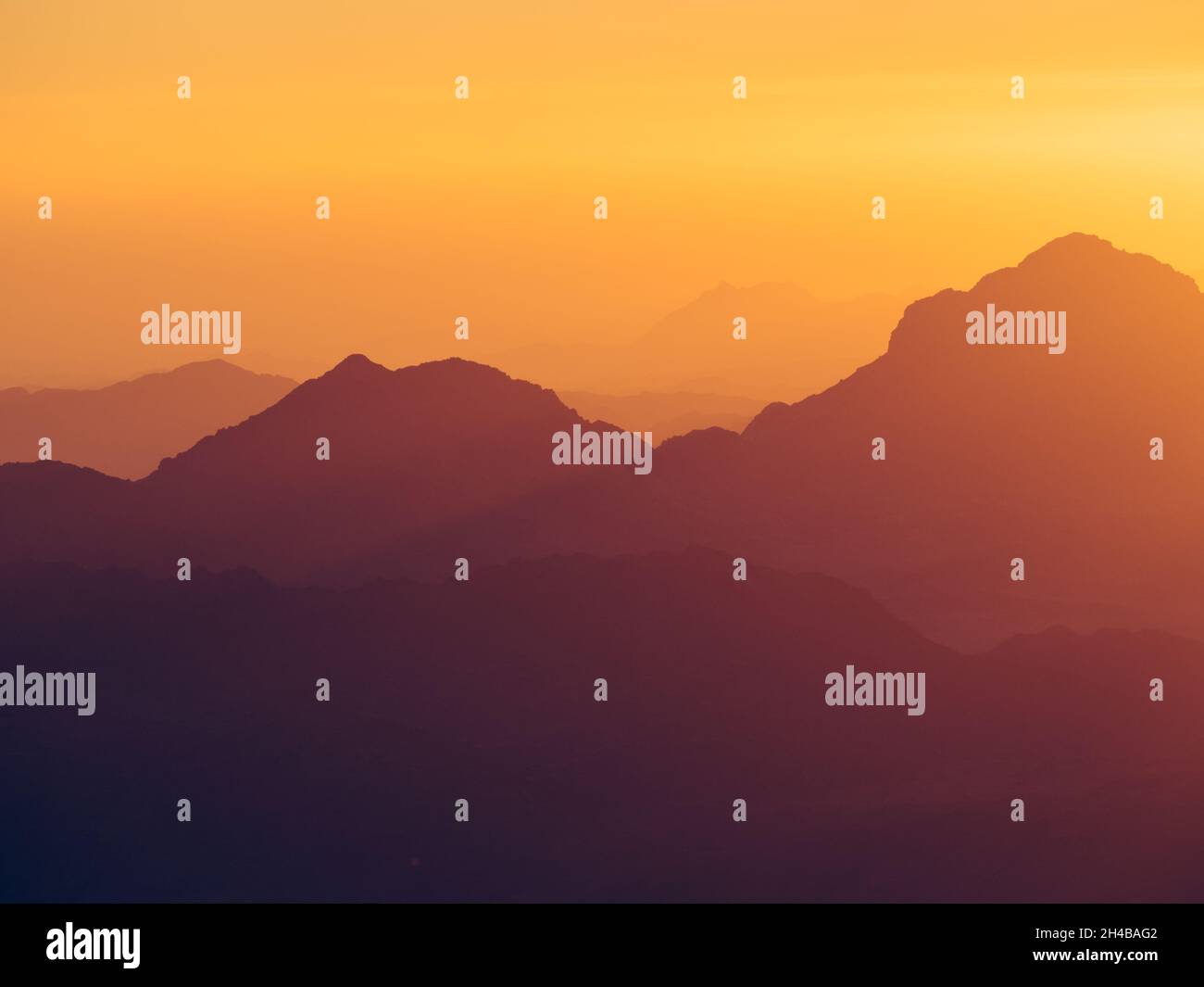 Mesmerizing view of the high hills on a foggy day at sunset Stock Photo ...