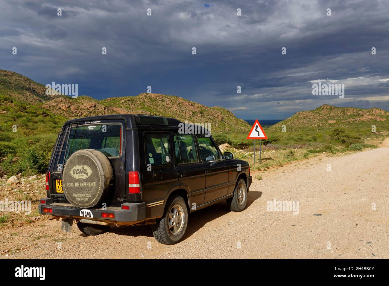 Car (Land Rover Discovery 1) on gravel road (D 2315) in the Erongo Mountains west of Omaruru, Omaruru District, Erongo Region, Namibia Stock Photo