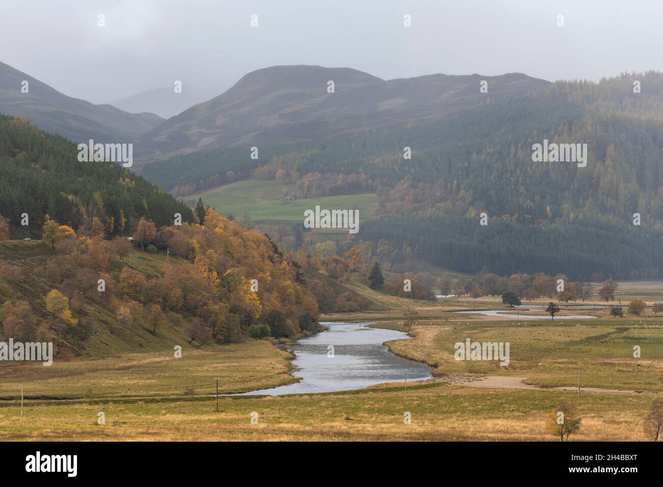 The River Dee Winding Through Colourful Autumn Countryside on the Mar Lodge Estate in the Cairngorms National Park in the Scottish Highlands Stock Photo