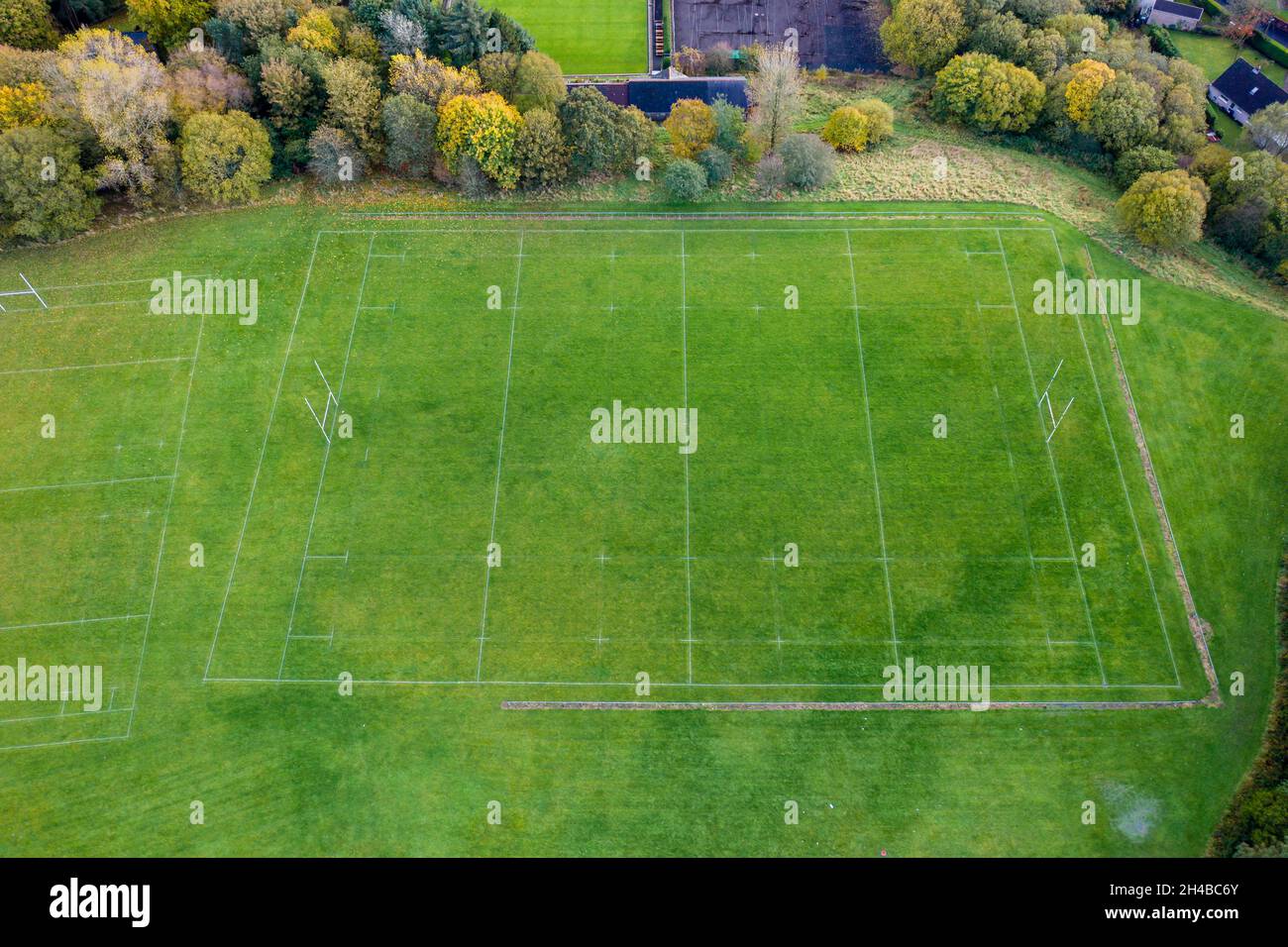 Aerial view of a fully marked Rugby Union pitch surrounded by trees in