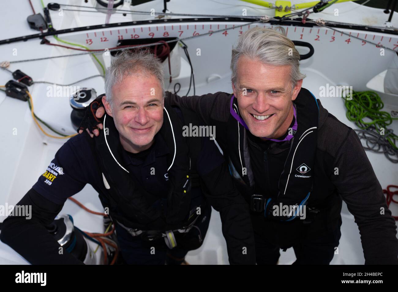 Crew member, Peter (l) and Skipper, Guillaume (r)pose on Lord Jiminy during the 2021 Return to Sailing Celebration Race organised by the Ocean Racing Club Of Victoria in Melbourne. Melbourne celebrates after ending the worlds longest and most draconian Covid lockdown. Stock Photo