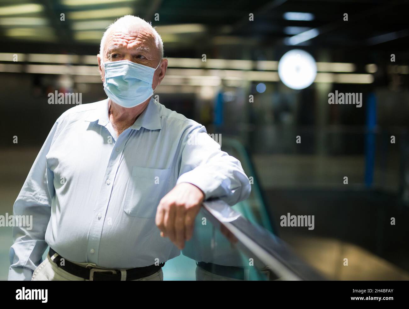 Old man in face mask standing in airport Stock Photo - Alamy