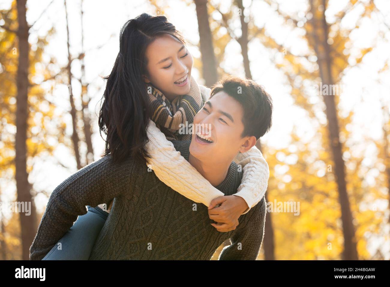 Young man carrying his girlfriend Stock Photo