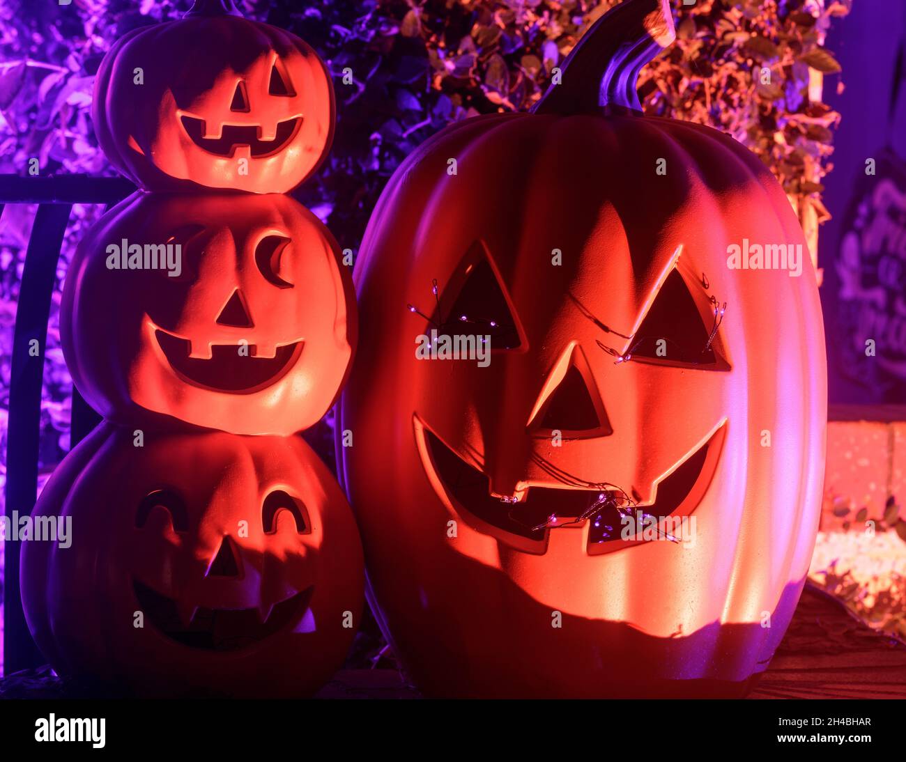 Spooky lit Jack o lanterns decorating house porch in Halloween Stock ...