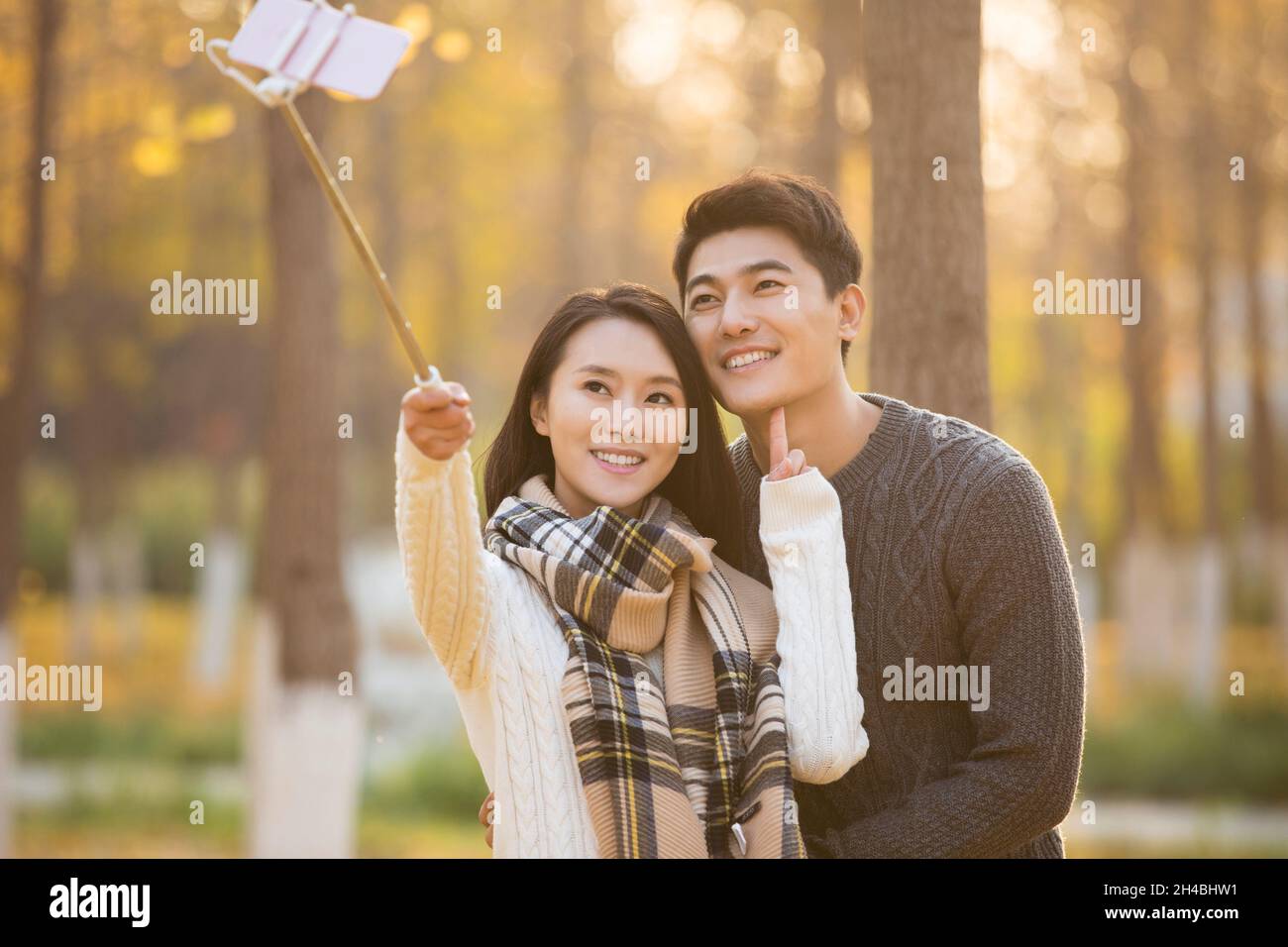 Happy young couple taking selfies with their mobile phone Stock Photo