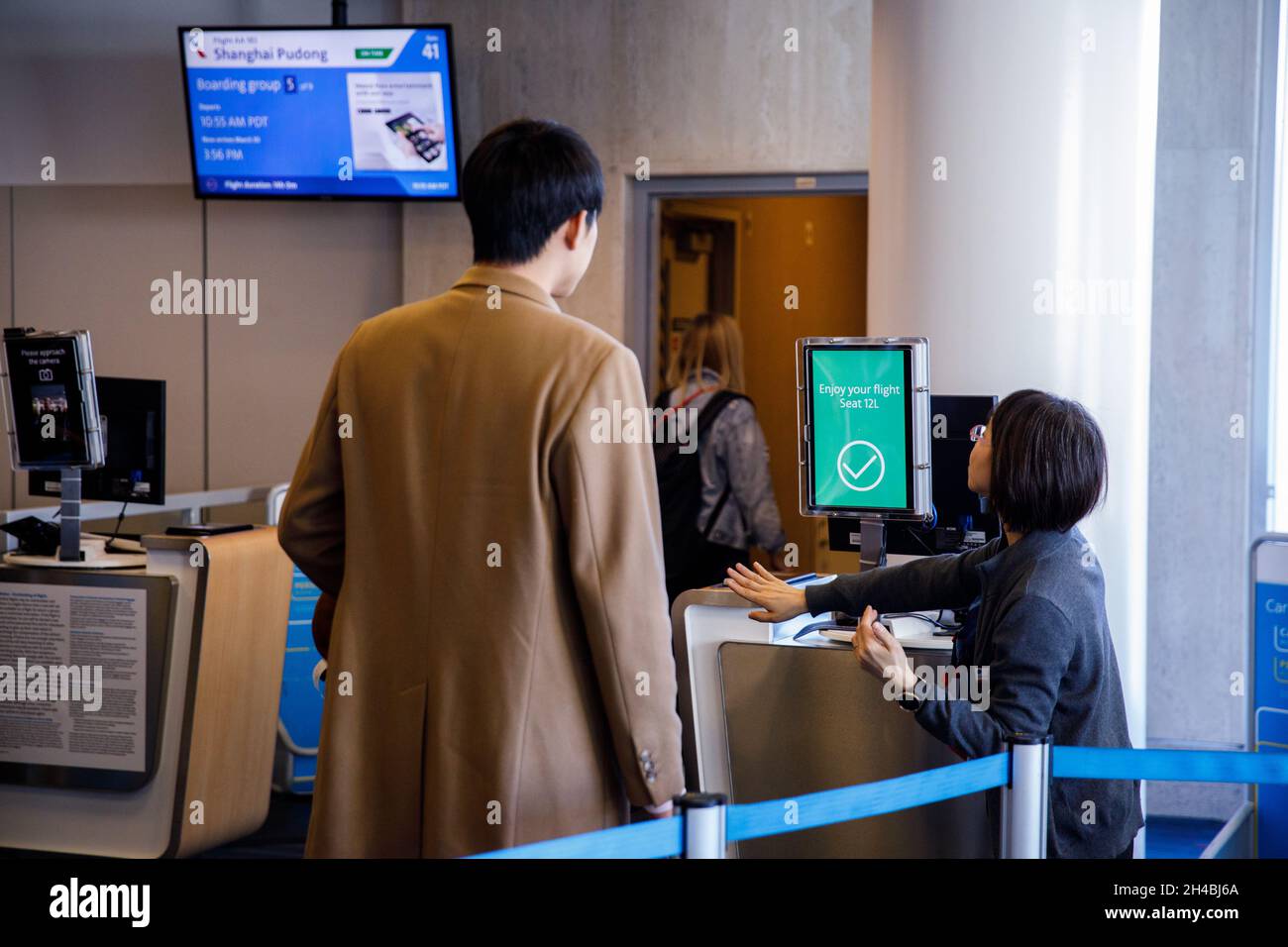 Los Angeles, California, USA. 29th Mar, 2019. Gate agents assist passengers using facial