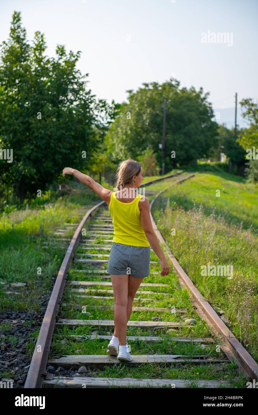 Woman walks along railway hi-res stock photography and images - Alamy