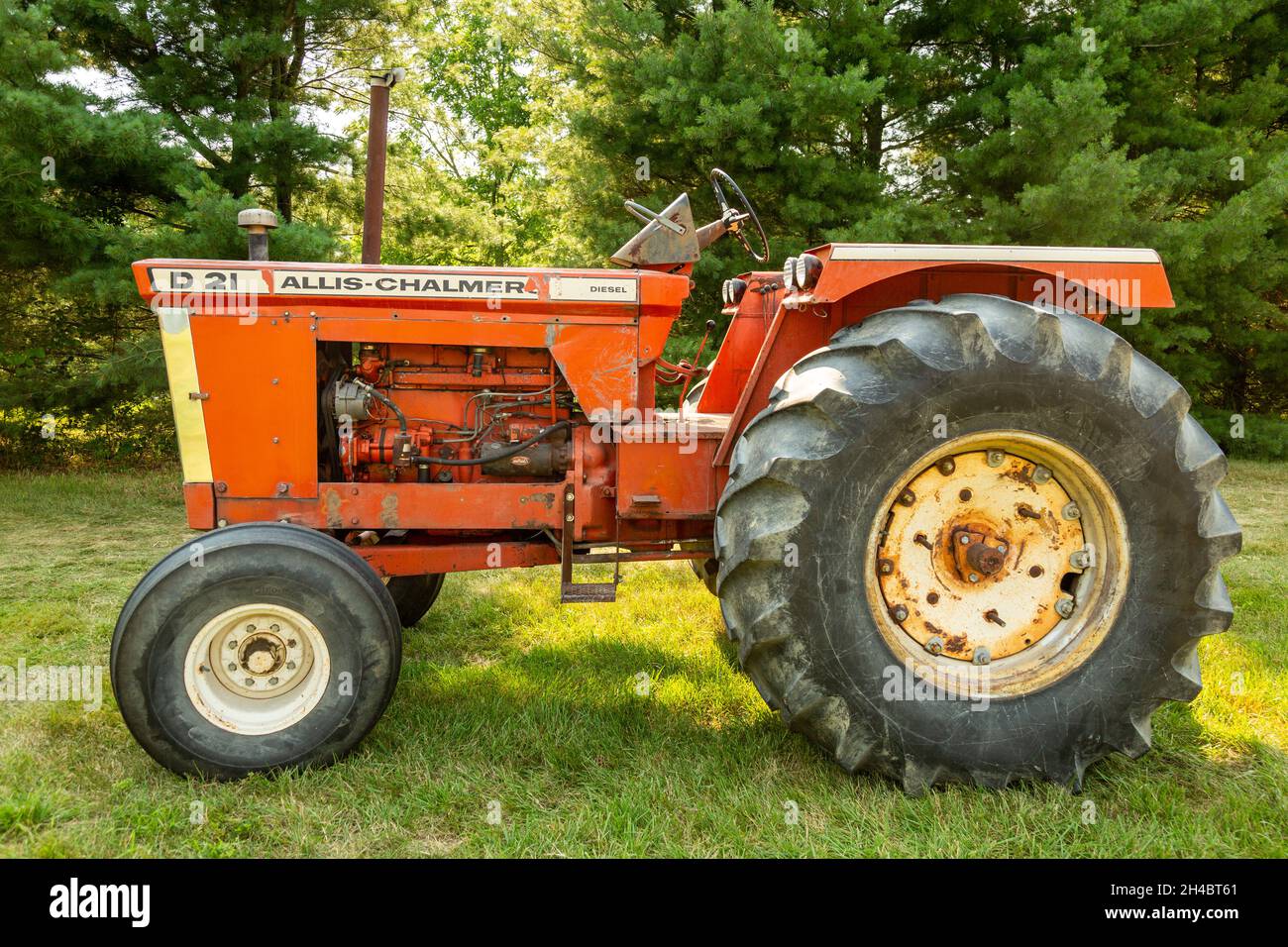 An orange antique Allis-Chalmers D21 row crop farm tractor in Warren, Indiana, USA. Stock Photo